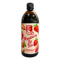 Bud to Cup Strawberry Ice Tea pure ceylon tea concentrate in a 750 ml dark amber bottle with a black cap and a cream-colored label featuring red strawberries.