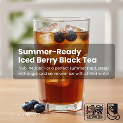 Glass of iced berry black tea with blueberries on a wooden surface, featuring Ceylon Tea branding.