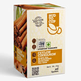 Box of Ceylon Cinnamon black tea from Hatton Tea Co. with cinnamon sticks on a white background.