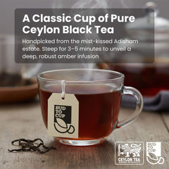 Glass cup of black tea with a 'Bud to Cup' tag on a wooden surface, featuring text about Ceylon black tea.