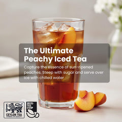 Glass of peachy iced tea with peaches on a table, featuring Budweiser Ceylon Tea branding.